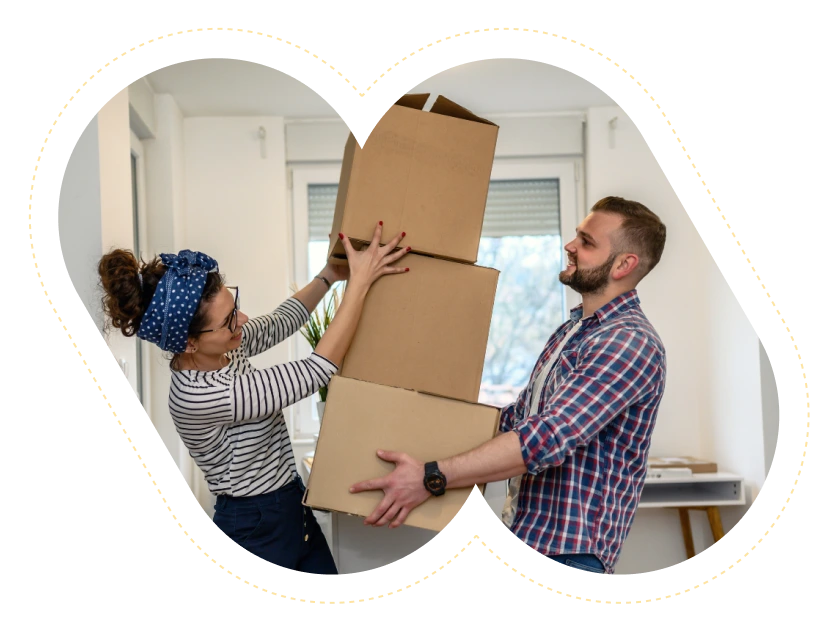 couple holding stacked boxes