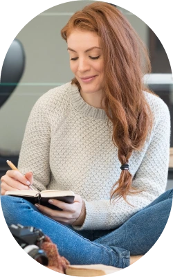 woman writing on her personal notebook