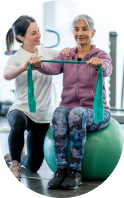 elderly woman being assisted on a fitness training